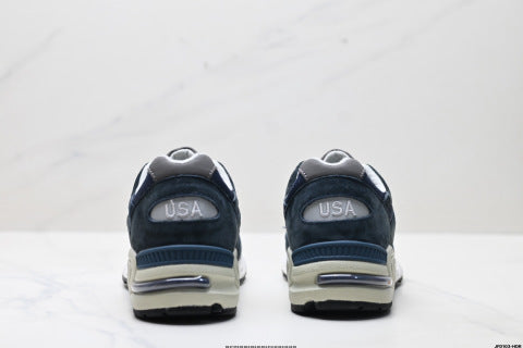 New Balance NB 990 series athletic shoes, breathable mesh cushioning, casual running shoes.